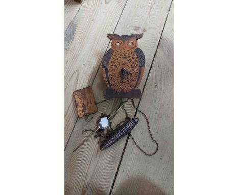 A small vintage mixed wood novelty wall timepiece in the form of an owl with moving eyes action