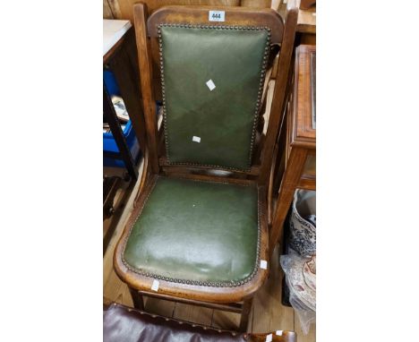 An early 20th Century stained beech framed chair with studded green leather seat and back - sold with a beech stool with flan