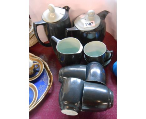 A Branksome pottery part tea set in the black and green colourway comprising teapot, hot water jug, milk and sugar, five cups