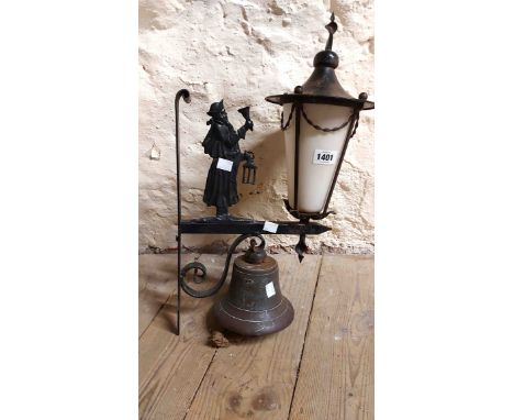 A vintage wrought and cast iron porch light with figural night watchman decoration and an opaque glass shade set with bronze 