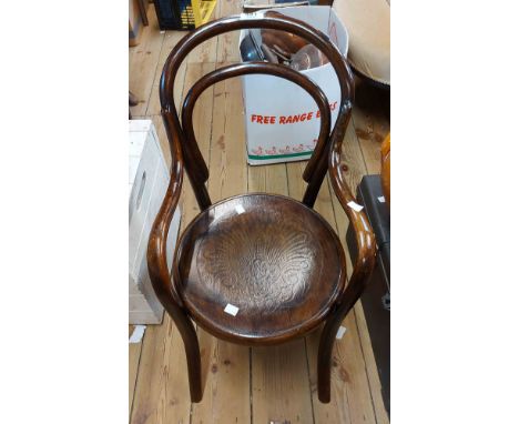 An early 20th Century Fischel bentwood child's chair with hoop back and machine pressed decoration to seat panel