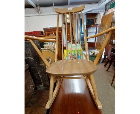 A Ercol light elm stick back rocking chair with original foil label