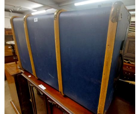 A vintage cane bound travelling trunk with blue weather coat finish