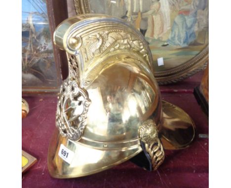 A reproduction Victorian style brass fireman's helmet