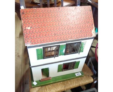 A vintage Tri-ang style doll's house containing a small quantity of furniture, figurines, etc.