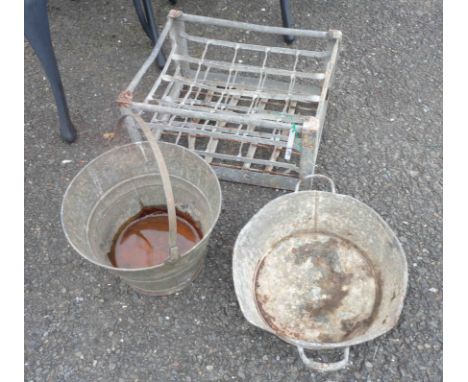 A vintage galvanised bottle crate with pierced initials 'D.C.' - sold with a galvanised bucket and similar bowl