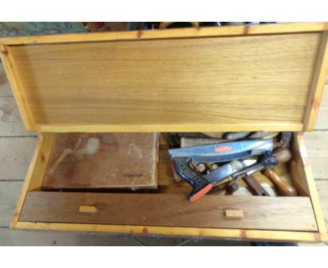 A carpenter's style toolbox containing a quantity of tools including hammer, chisels, etc.