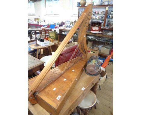 A vintage wooden harp with sound box base - in need of restringing