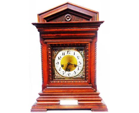 An early 20th Century mahogany cased table clock of architectural design with brass and silvered dial, with Junghans eight da