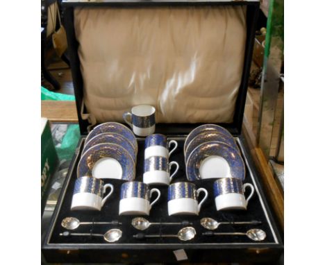 A fitted case containing a Woods Ware coffee set comprising six coffee cans and saucers with six silver coffee bean spoons - 