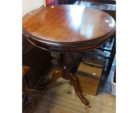 A 59cm diameter reproduction mahogany pedestal table, set on turned pillar and tripod base