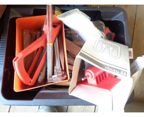A crate containing a quantity of tools including chisels, hammers, etc.