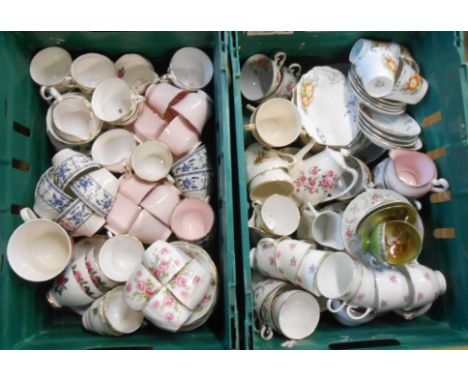 Two crates containing a quantity of assorted china including teacups, saucers, etc.