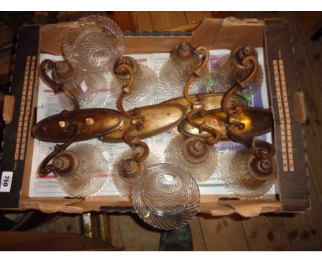 A set of four cast brass twin light wall sconces, with cut glass shades of bell form, also two spare shades