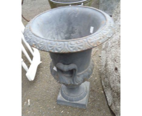 A 40cm high old cast iron planter of semi-reeded urn design