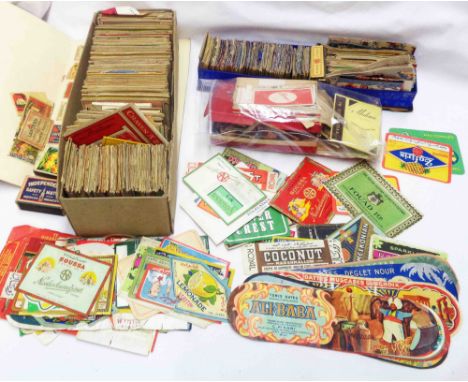 A box containing a collection of vintage food and drink labels, matchbox covers, cigarette packs and other trade ephemera - s