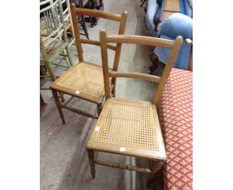 A pair of Edwardian oak framed bedroom chairs with rattan seat panels