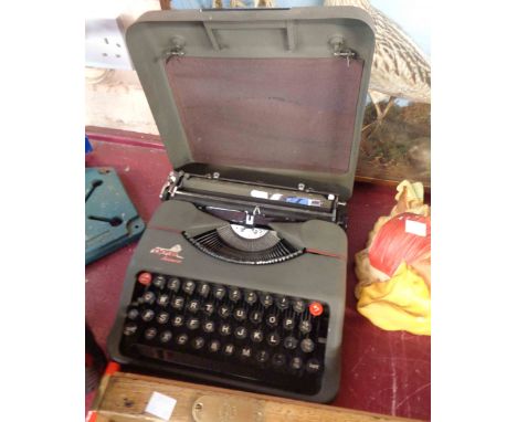A vintage Empire Aristocrat portable typewriter in original metal carry case