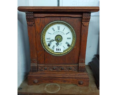 An antique oak cased shelf clock with dial marked for Fattorini &amp; Sons, Bradford, with American spring driven alarm movem