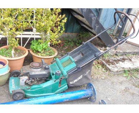 A Qualcast Suffolk petrol lawn mower with Tecumseh 3.7 HP engine and grass box
