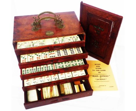 An antique Chinese Mahjong set in stained wood drawer fitted chest with sliding front and bone pieces