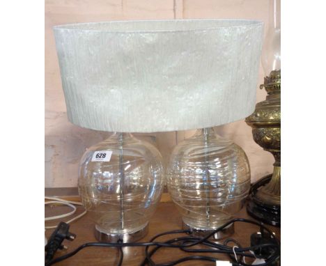 A pair of modern hollow blown glass table lamps, with trailed ribbon decoration with chrome plated fittings - with a double l