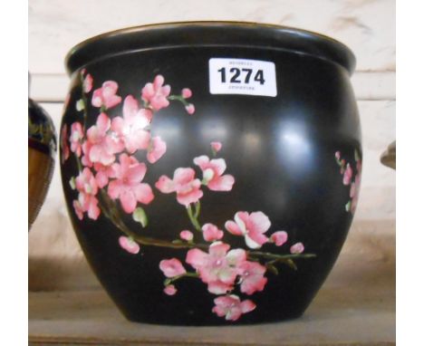 A Carltonware jardiniere with hand-enamelled prunus decoration on a black ground
