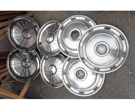 Seven assorted vintage car wheel hubs comprising one set of four and three others