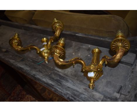A pair of brass cast wall mounted light brackets