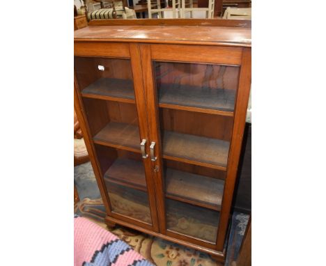 An Edwardian mahogany framed display case or book shelf having rolled glass frontage