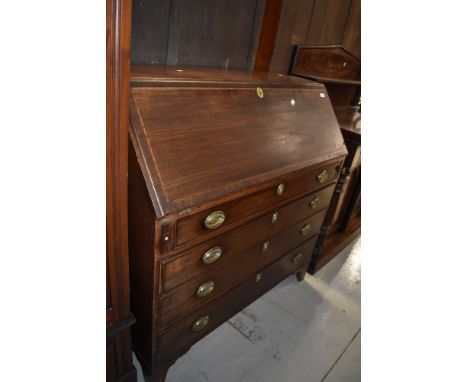 A 19th Century and later mahogany bureau having inlay decoration to flap, brass handles and bracket feet