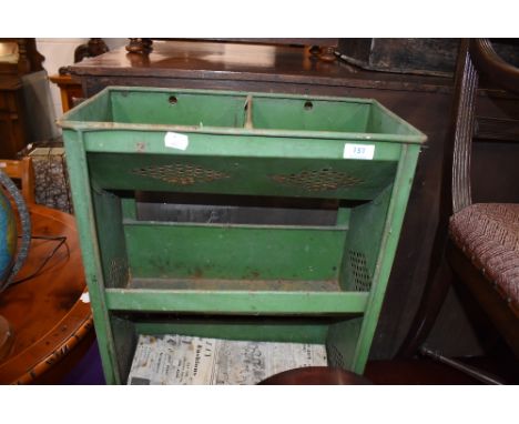 A metal framed utility shelf or vegetable storage unit