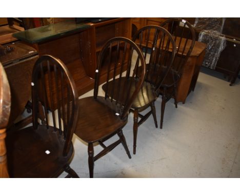 A set of four dark stained hoop and stick back dining chairs (similar to Ercol)