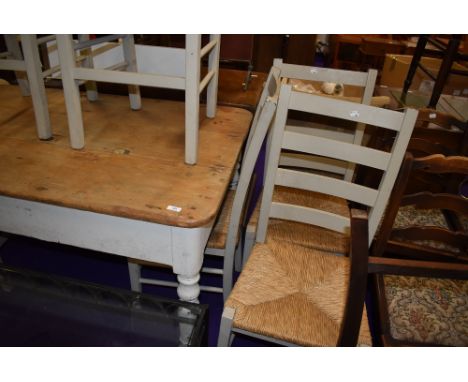 A vintage farm house style kitchen table and six chairs having straw seats and ladder backs