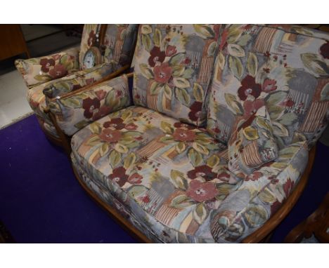 A mid century style Ercol two seater couch and matching arm chair in a mid stain