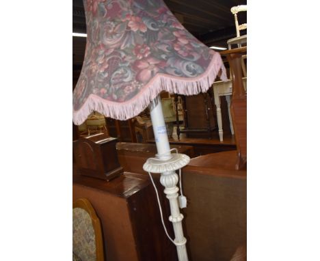 A modern standard lamp having turned and carved base