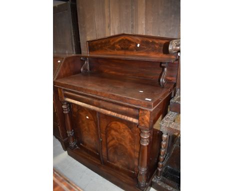 A Victorian mahogany sideboard having shelf back, turned column, concealed frieze drawer and double cupboard