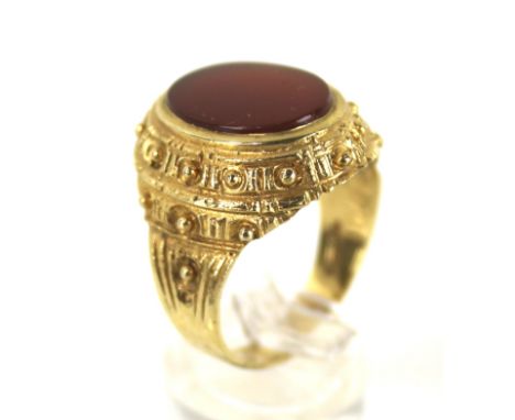 A vintage 9ct gold and carnelian oval signet ring. The plain oval carnelian matrix rub-over set within a bead and panel chase