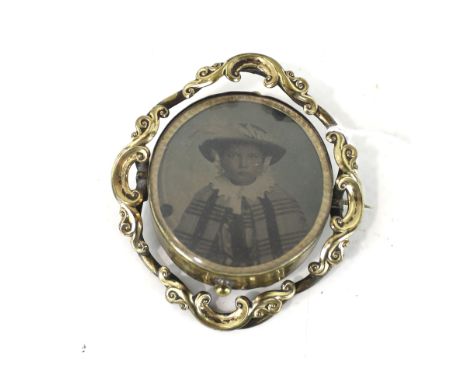 An early-mid Victorian gold-plated swivelling 'photographic' brooch. The portraits of a man and a woman thought to be an ambr