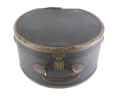 A vintage leather hat box. The hinged lid opening to reveal an interior lined with floral fabric, with a handle to the top, m