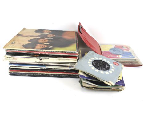 A collection of vintage vinyl records. Including The Beatles, Cliff Richard, The Zombies, etc. the majority in the original s