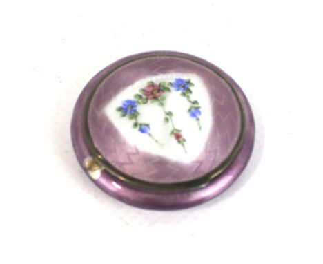 A Continental polychrome enamelled round compact. The cover depicting three floral pendants on a white ground within a mauve 