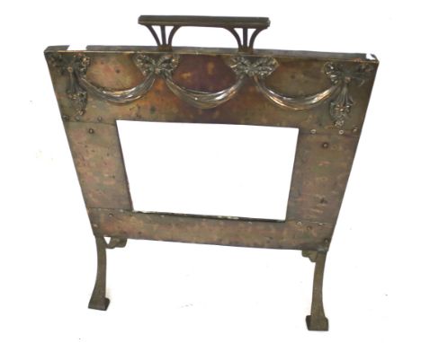 An early 20th century 'Arts and crafts' style fire screen. With riveted metal work and a central bevel edge mirror on splayed