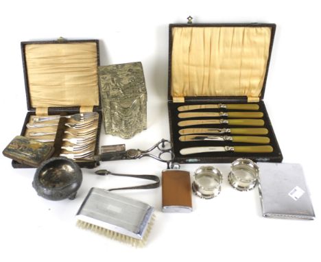 A collection of silver and silver-plate. Including a pair of silver napkin rings, a pair of grape scissors, a boxed set of fl