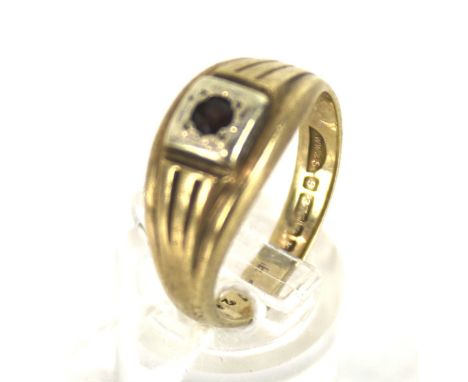 A vintage 9ct gold and garnet signet ring. The small round garnet grain set within a square head on a tapering shank hallmark