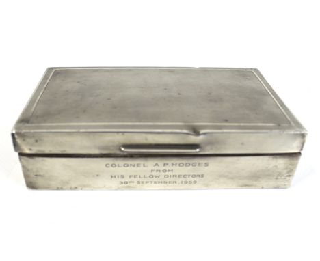 A silver rectangular cigarette box. With an engine turned hinged cover, the front engraved with a presentation inscription da