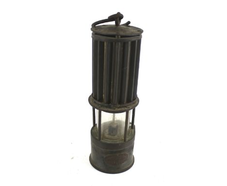 A Miner's lamp by The Premier Lamp Co, Leeds. With a corrugated effect upper body, H27cm Condition Report: Postage within the