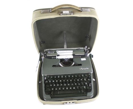 An Olympia De Luxe portable manual typewriter. In a green and grey carry case, L37cm