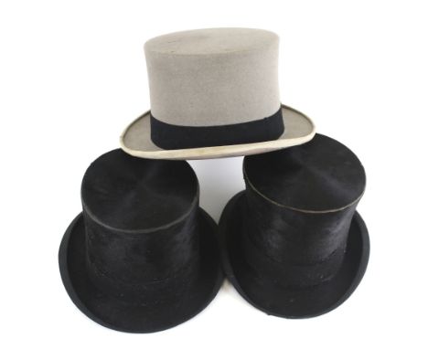 Three vintage top hats. Comprising a Harrods grey felt example, a black silk hat by Cooke & Co and one other