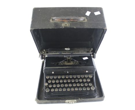 A vintage Royal manual typewriter. In a black travel case with a leather handle to the top, L32cm